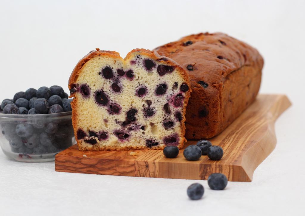 Blueberry Vanilla Bread · Ultra moist vanilla cake batter loaded with giant infusions of whole blueberries. Full large loaf ready to slice as you wish.  Made in a facility that uses dairy, eggs, nuts, and wheat products.