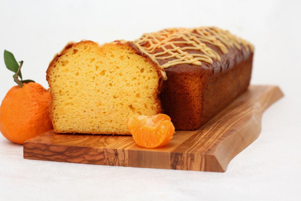 Mandarin Orange Yogurt Bread · Ultra moist with mandarins, yogurt and a light touch of pineapple, drizzled with citrus glaze. Full large loaf ready to slice as you wish. Made in a facility that uses dairy, eggs, nuts, and wheat products.