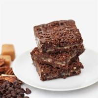 Praline Fudge Bar · Chunky chocolate, soft toffee and dark chocolate in a pecan brownie. Box of 12 bars. Baked i...