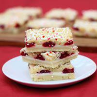 Raspberry Cheesecake Bar · Cheesecake with sweet raspberry filling between layers of shortbread.  Drizzled with white c...