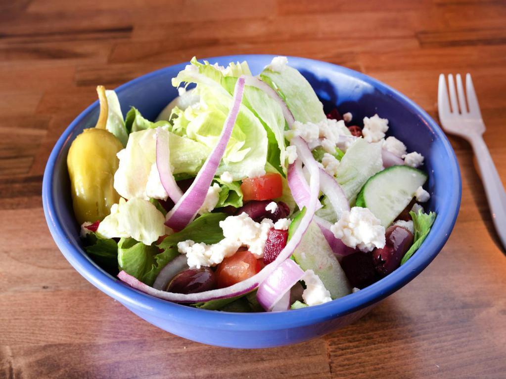 Greek Salad · Feta cheese, tomatoes, olives, mixed greens and grape leaves.