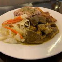 Curry Goat · Served with rice and peas, white rice or macaroni and cheese, salad or veggies and plantains.