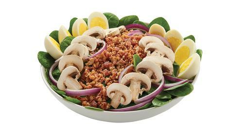Spinach Salad · Tender baby spinach greens topped with crumbled bacon, red onion, fresh mushrooms and hard-boiled eggs.