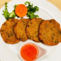 10. Fish Cake · Ground fillets of fish mixed with red curry and string bean, served with a cucumber sweet ch...