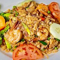 46. Thai Pineapple Fried Rice · Fried rice with shrimp, chicken, onion, green peas and pineapples.