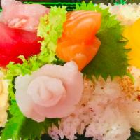 47. Chirashi · 14 pieces assorted sashimi over seasoned rice. Served with choice of side.