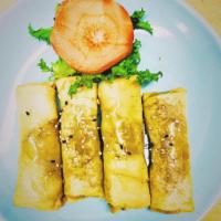 4 Fried Banana · Banana wrapped in spring rolls skin topped with honey and sesame seeds.