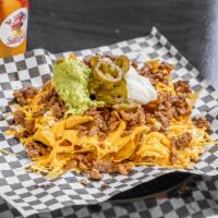 Nachos · Nacho chips, jack and cheddar cheese, guacamole, cheese sauce- jalapenos and choice of meat.