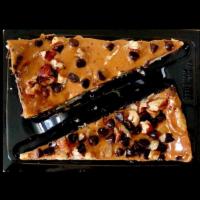 Turtle Cheesecake · Creamy cheesecake on a chocolate graham crust topped with rich caramel, pecans & chocolate. ...
