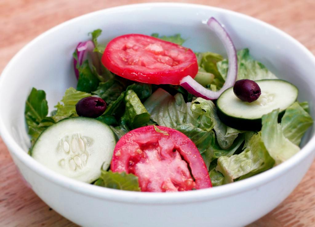 House Salad · Served with Romaine hearts, tomato, cucumber, red onion, olive and choice of dressings