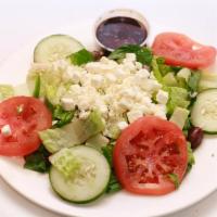 Greek Salad · Romaine hearts, cucumber, tomato, olive, red onion, feta cheese and balsamic vinegar.