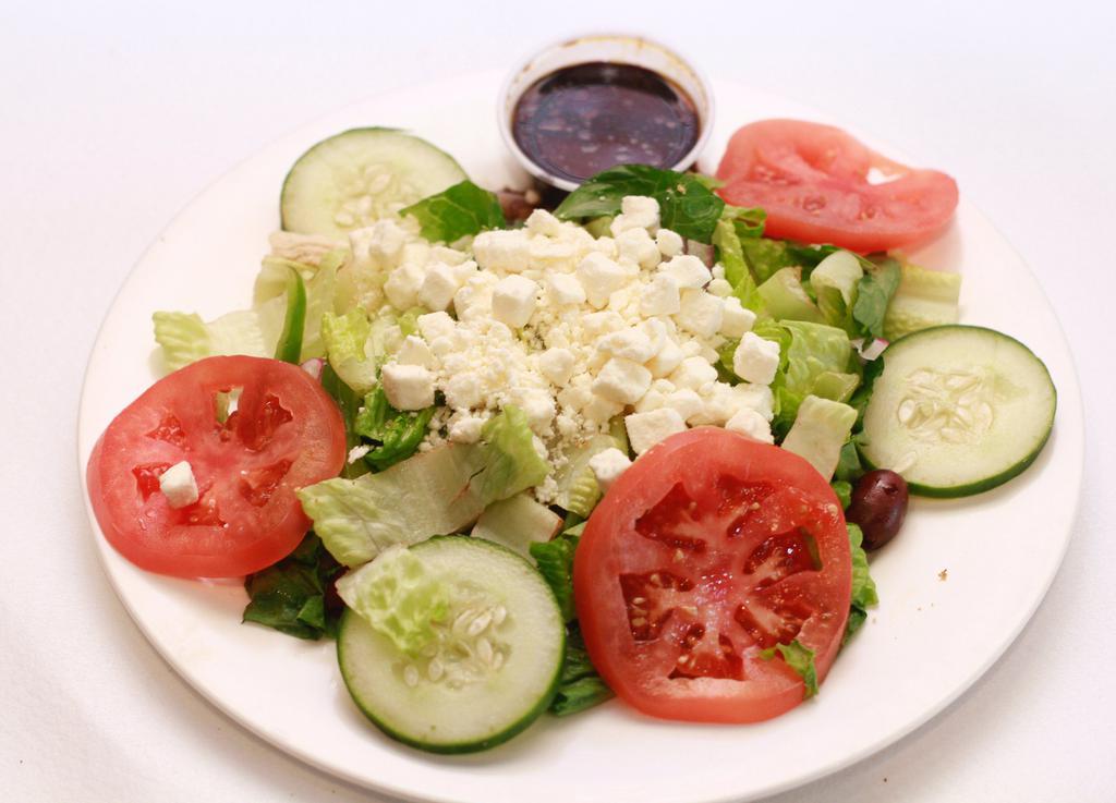 Greek Salad · Romaine hearts, cucumber, tomato, olive, red onion, feta cheese and balsamic vinegar.