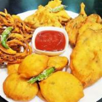 Assorted Pakora Platter · Fresh cut garden vegetables coated with mildly spiced chickpea batter and deep fried.