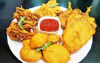 Assorted Pakora Platter · Fresh cut garden vegetables coated with mildly spiced chickpea batter and deep fried.