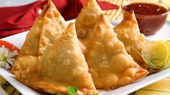 Aloo Samosa · Crispy turnovers with delicately spiced potatoes and green peas, served with mint and tamari...