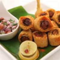 Cut Mirchi · A spicy chilli pepper dipped in Chickpea batter and deep fried, cut into small pieces and mi...