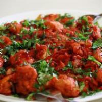 Chicken 65 · Chicken deep fried with punchy flavors of curry leaves, ginger, garlic, chilies and spices.