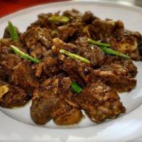 Pepper Mutton Fry · Tender baby goat meat, pan fried with simple spices and crushed peppercorns and garnished wi...