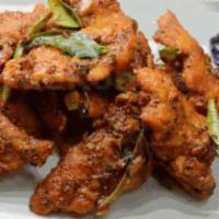 Apollo Fish · Fillets of fish, marinated in a spiced batter, deep fried and tossed in curry leaves and pep...