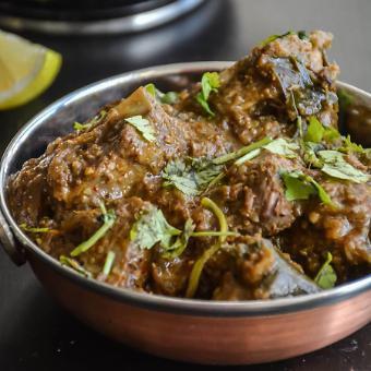 Lamb Vindaloo · Chicken and potatoes simmered in a delicious blend of red chilies, ginger, garlic and spices.