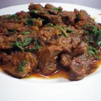 Bhuna Goat · Well-cooked goat pieces tossed with spicy pepper house masala.