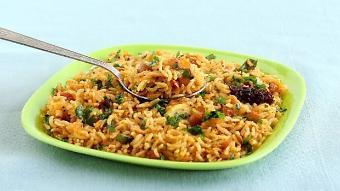 Tamarind Rice · Tangy rice made of rice, tamarind paste and embellished with peanuts and red chilies.