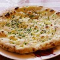 Onion Kulcha · Finely chopped onions mixed with spices stuffed in fresh dough baked in tandoor clay oven.