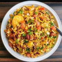 Bhel Puri · Puffed rice, crushed tortillas, potatoes, tomatoes, onions tossed with chilies and tamarind ...