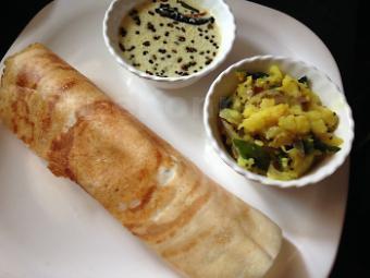 Masala Dosa · Dosa filled with mildly spiced mashed potatoes and onions. Thin crepe made with fermented rice and lentil batter.