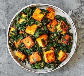 Saag Paneer · Spinach cooked with homemade cottage cheese in a mildly spiced onion and tomato sauce.