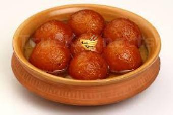Gulab Jamun · Deep fried milk and flour based spongy balls soaked in cardamom sugar syrup.