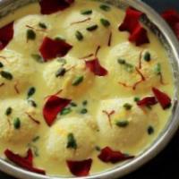 Rasmalai · Spongy cottage cheese balls dipped into flavored milk syrup.