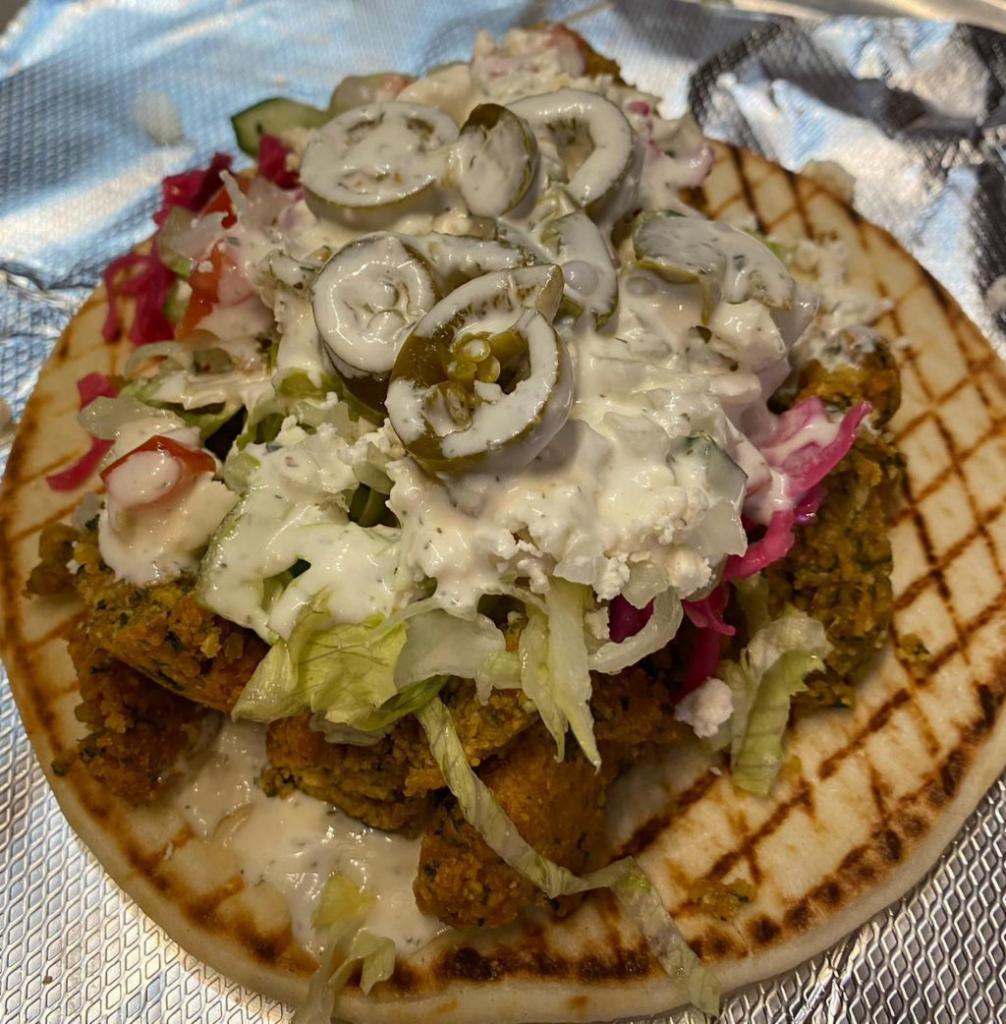 Gyro · A Beef/Lamb Mix or Chicken Gyro. Wrapped in a Greek Pita Bread with Fresh Toppings of your Choice and Sauce. 