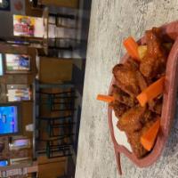 Chicken Wings · 8 wings available naked or coated in one of our special sauces. Served on a bed of chips wit...