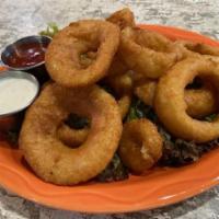 Onion Rings · A full platter of large white onion rings covered in a beer batter and served with your choi...