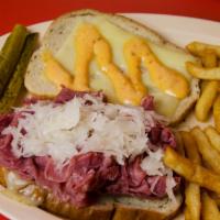 7. Reuben Sandwich · Corned Beef topped with swiss cheese, sauerkraut, pickles, and Thousand Island Dressing, inc...