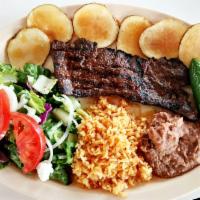 22. Carne Tampiqueña (Steak Dinner) · Skirt Steak Dinner served with rice, beans, side salad, a grilled jalapeño, and fresh fried ...