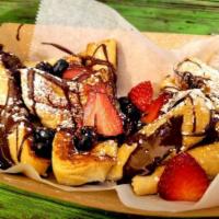 French Toast · Four Slices of Golden Brown Vegan Brioche Bread Served with Fresh Berries and Nutella and Or...