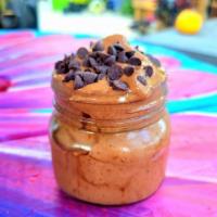 Banana and Chocolate Ice Cream · Frozen bananas and raw cacao powder ice cream, topped with chocolate chips and served in a c...