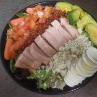 Sam’s “Cobb” Salad · Crisp chopped romaine greens with rows of bleu cheese, sliced turkey, diced tomato, diced ba...