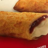 Raspberry Cheesecake Fried Chimi · 3 pieces dusted with powdered sugar.