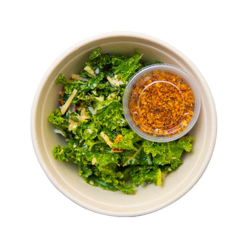 Cashew Kale Caesar with Seasoned Breadcrumbs · Tuscan and green kale, spicy cashews, shaved cauliflower, cashew Caesar dressing with breadcrumbs on the side. Vegan.  Contains tree nuts (cashew), wheat/gluten.