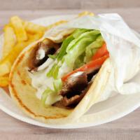 Lamb Gyro Sandwich · Gyro roast lamb wrapped in grilled, soft pita bread with crisp lettuce, tomato and special s...