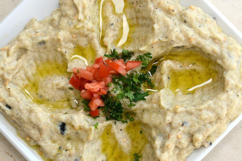 Baba Ghanoush · Fire roasted eggplants pureed with a touch of garlic, spices, lemon juice, fresh made tahini paste and olive oil. Vegan.