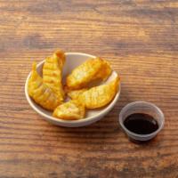 Chicken Gyoza · Crispy dumplings filled with minced chicken. Served with our gyoza dipping sauce. Contains g...
