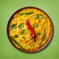 Sizzler Yellow Lentil · Loosened yellow lentils cooked with spices, tomato /spinach, green chili, cumin and onions.
