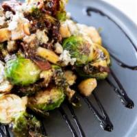 Crispy Brussels Sprouts · Crispy Brussels sprouts, beer glazed bacon, blue cheese, pears and balsamic reduction.