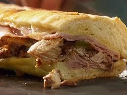 Sylvia's Cuban · Slowly Roasted Pork, Ham, Swiss Cheese, Butter, Pickles &
Mustard.