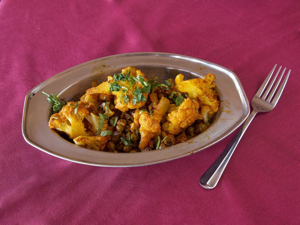 Mutter Gobi · Peas and cauliflower served with a Punjabi blend of spices.
