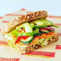 #6. Washington St. Sandwich · Veggie. Several layers of Swiss cheese topped with shredded lettuce, avocado, cucumbers, roa...